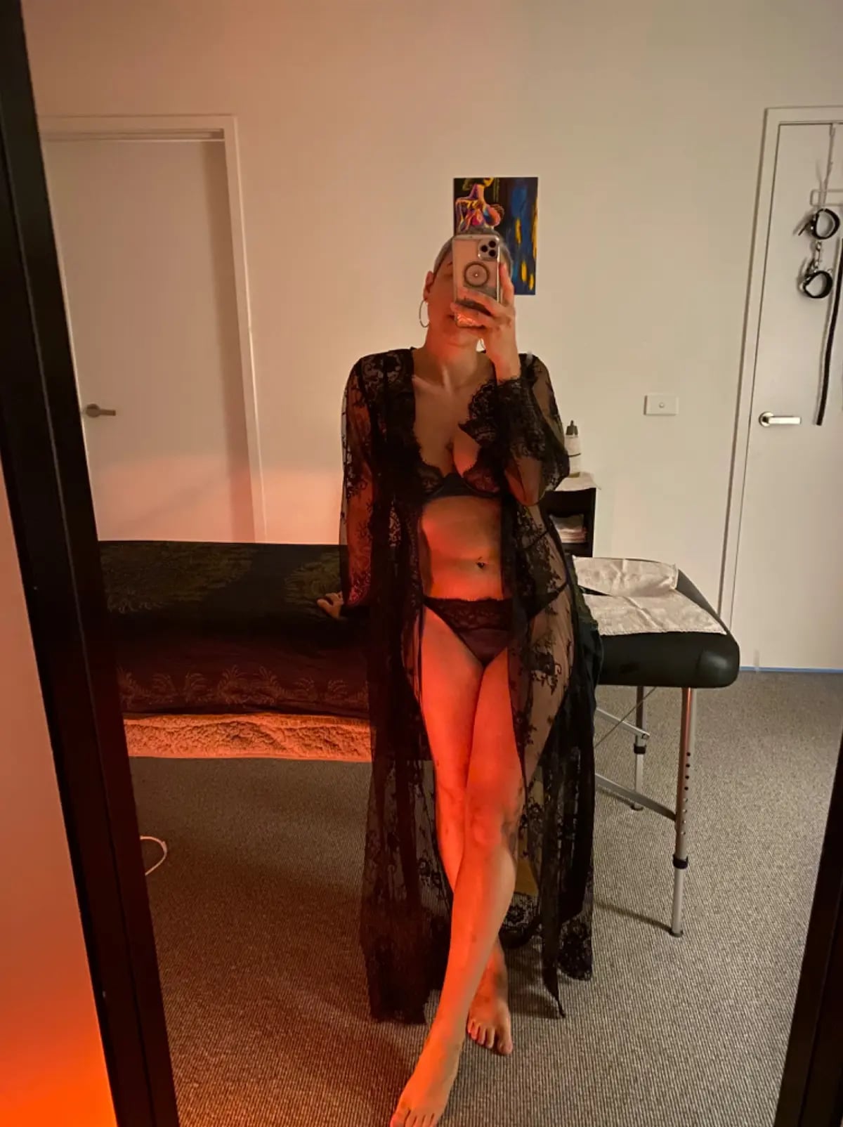 Prostate massage Melbourne, masseuse in a long black lace robe beside her massage table Prostate massage Melbourne, masseuse in a long black lace robe beside her massage table